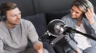 Using headphones with a podcast microphone to eliminate audio feedback and echo
