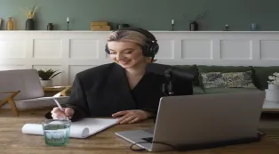 Woman wearing a Bluetooth headset with microphone while working from home