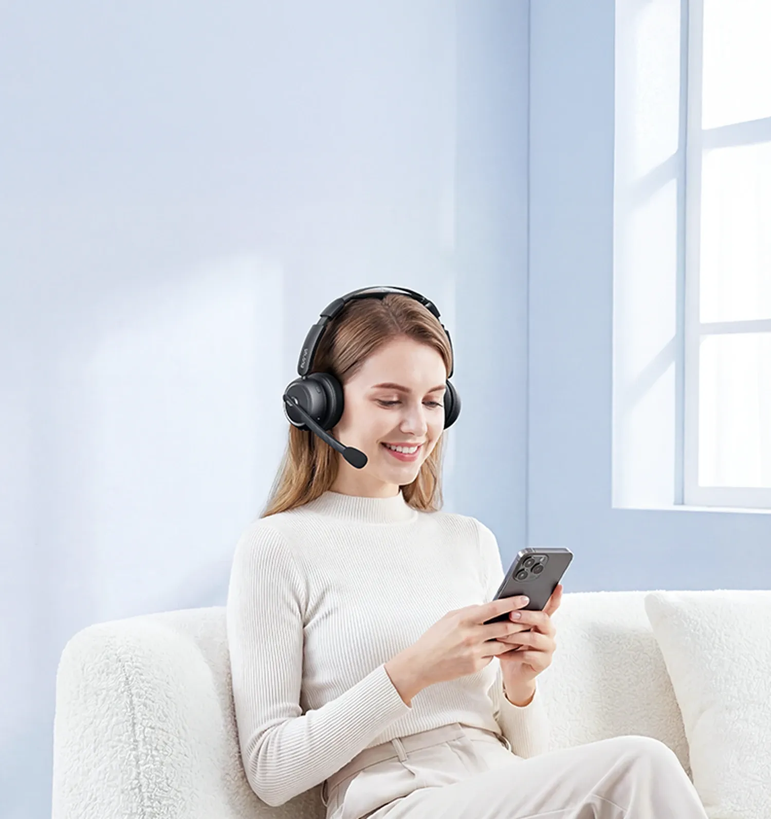 a woman wearing black wireless headphones with noise cancelling mic at home