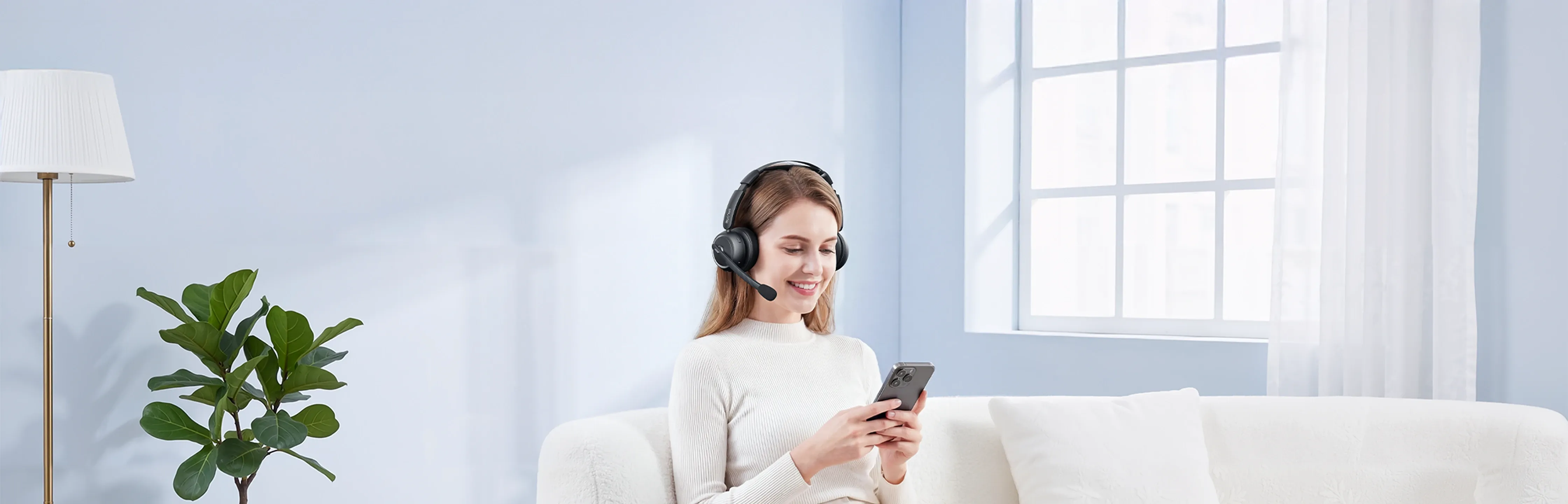 a woman wearing black wireless headphones with noise cancelling mic at home