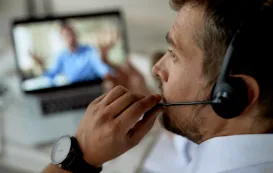 this business male is using his video conference headset