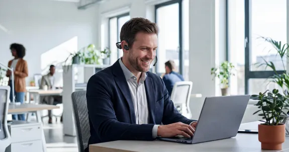 a male is working using his best headset for remote work