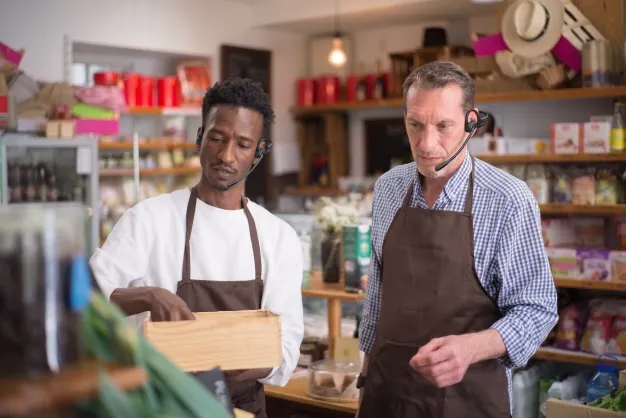 grocery store staff using open ear headset