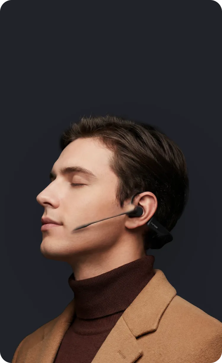 Side profile of a professional man wearing the lightweight Nuroum open-ear headset with boom microphone.