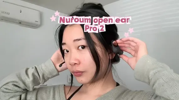 Video cover banner showing a woman putting on the Nuroum OpenEar Pro 2 headset, with title text overlay.