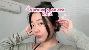 Video cover banner showing a woman putting on the Nuroum OpenEar Pro 2 headset, with title text overlay.